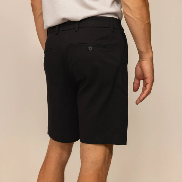 Man wearing Chino Shorts in Black, rear view.