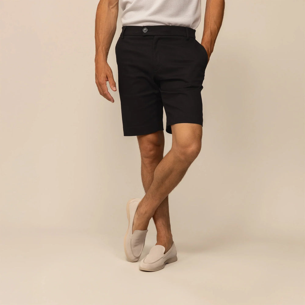 Man wearing Chino Shorts in Black, front view.