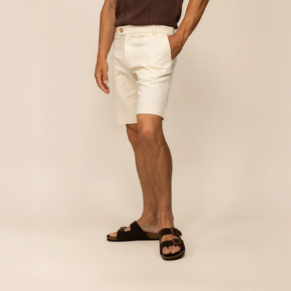Man wearing Marame Chino Shorts in Ivory Stone, front view.