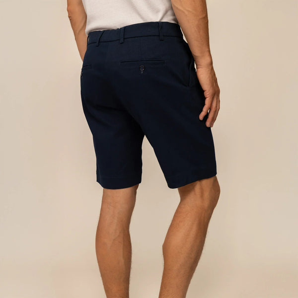 Man wearing Chino Shorts in Navy, rear view.