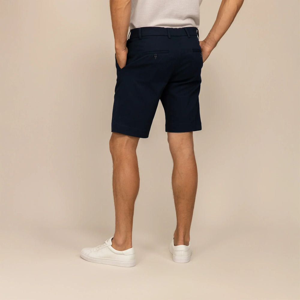 Man wearing Chino Shorts in Navy, rear view.