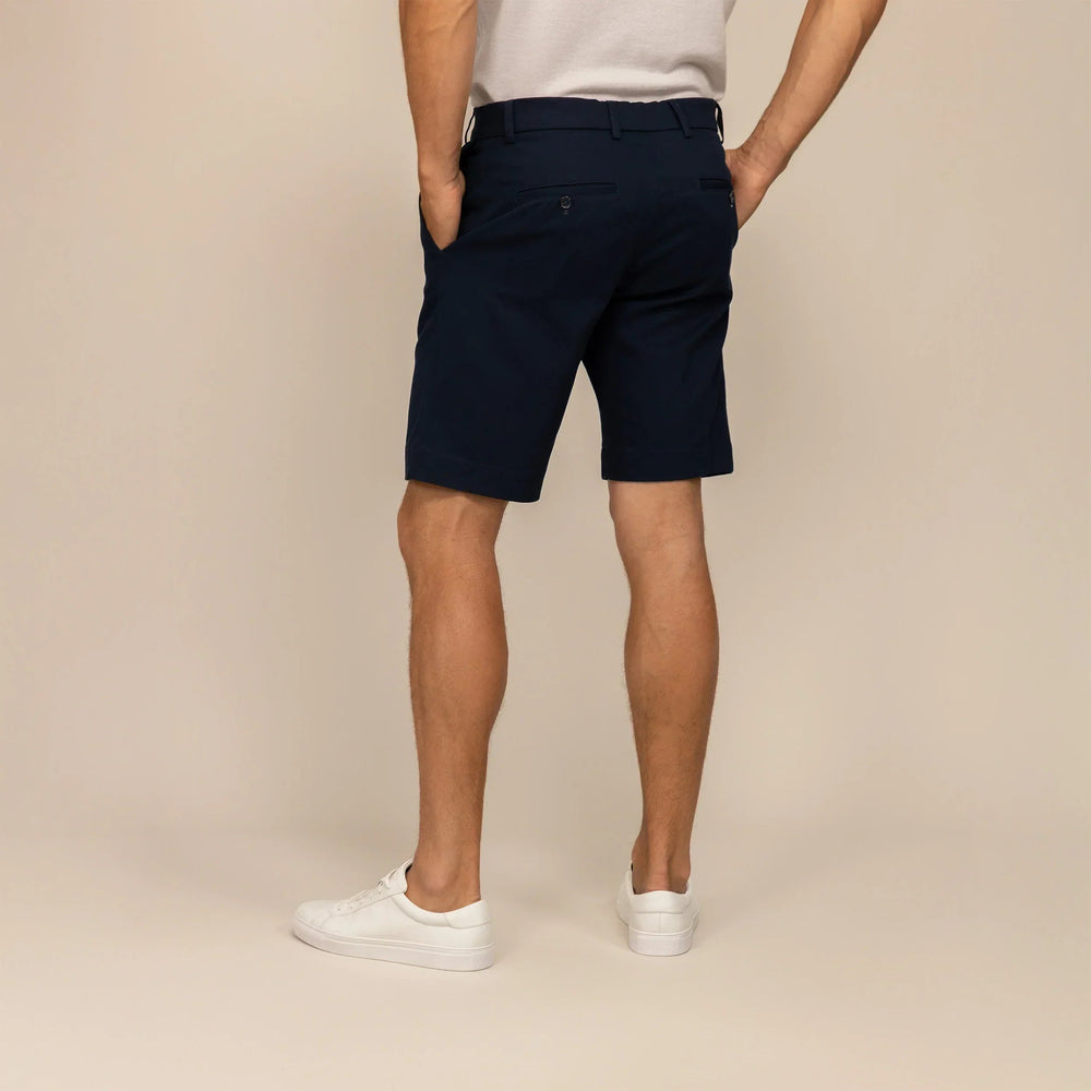 Man wearing Chino Shorts in Navy, rear view. |navy