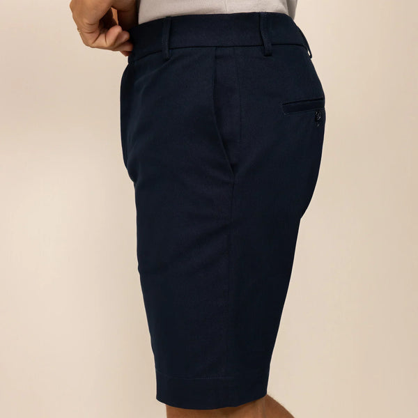 Man wearing Chino Shorts in Navy, side view.