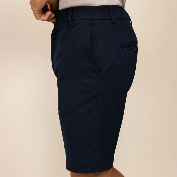 Man wearing Chino Shorts in Navy, side view. |navy