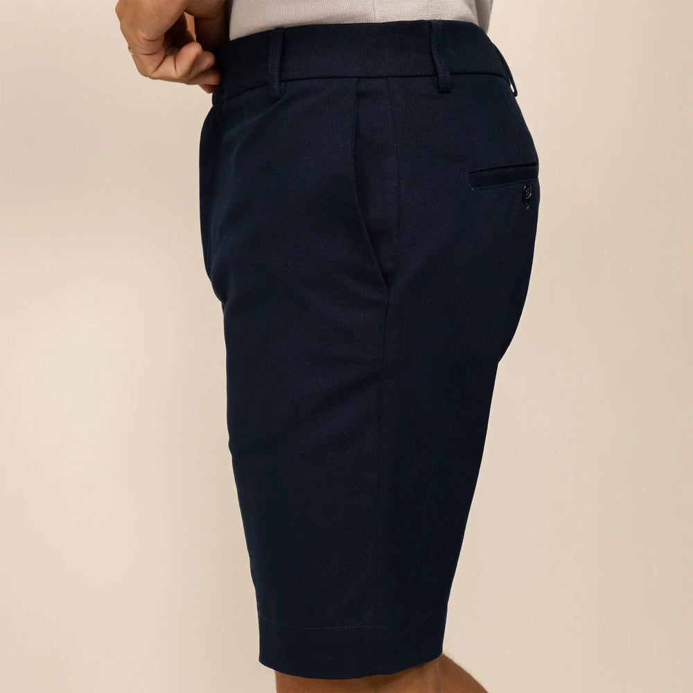 Man wearing Chino Shorts in Navy, side view. |navy