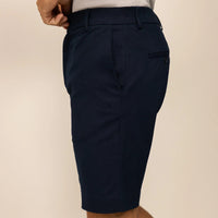 Man wearing Chino Shorts in Navy, side view. |navy