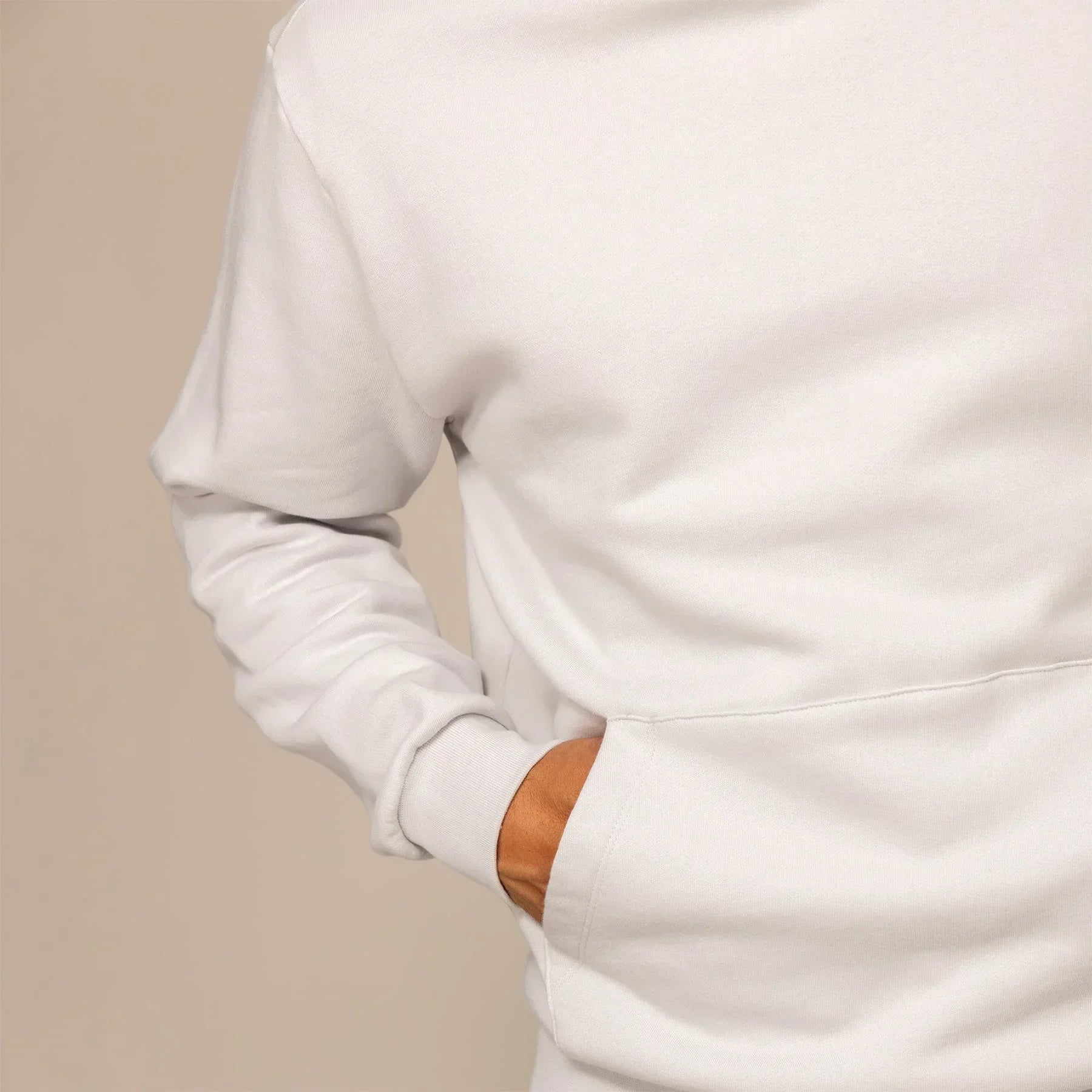 Man wearing a cotton fleece hoodie in Ash White, detail.|ash white