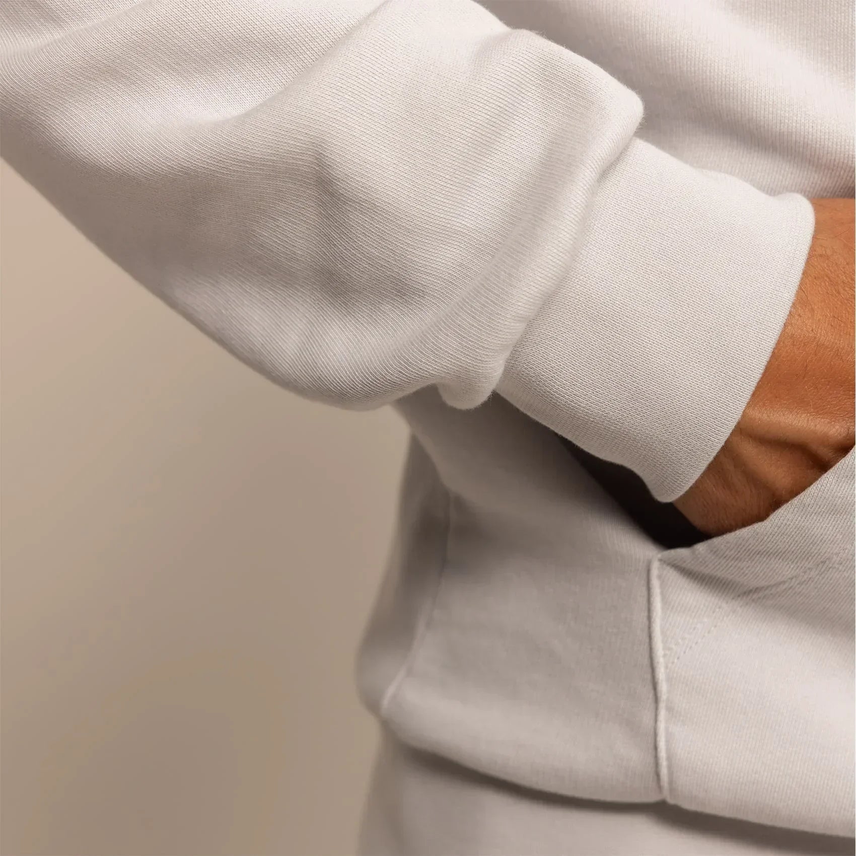 Man wearing a cotton fleece hoodie in Ash White, closeup.|ash white