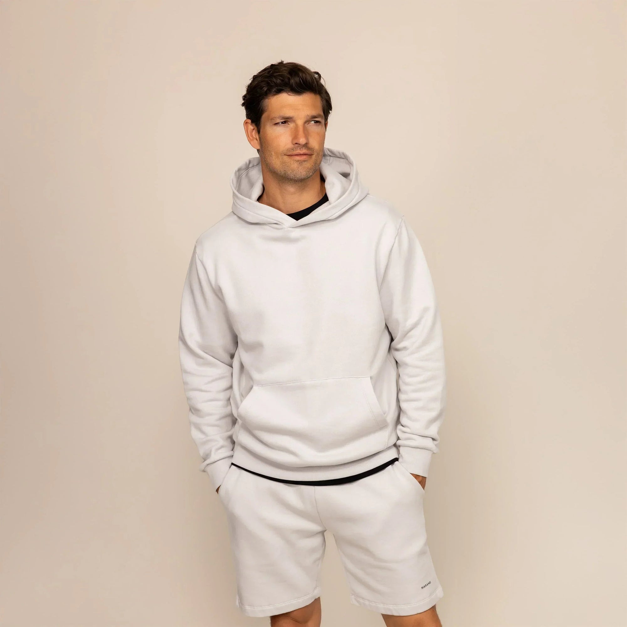 Man wearing a Marame cotton fleece hoodie in Ash White, front view.|ash white