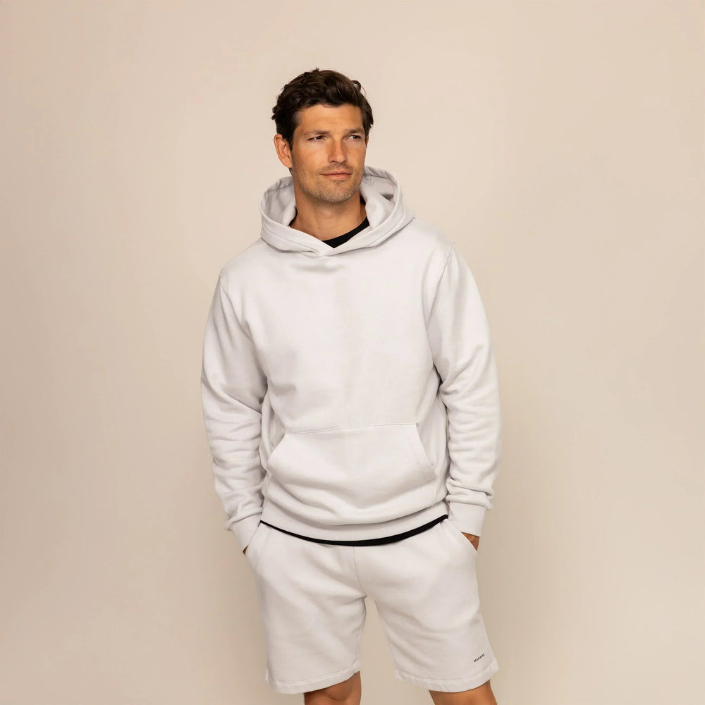 Man wearing a Marame cotton fleece hoodie in Ash White, front view.|ash white