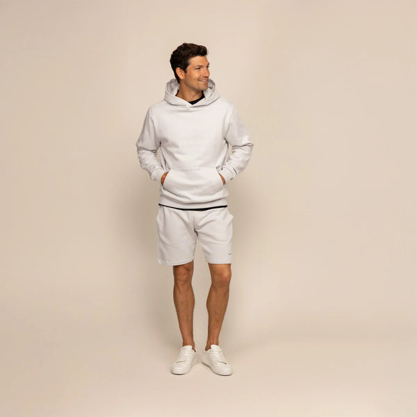 Man wearing a Marame cotton fleece hoodie in Ash White, full view.|ash white