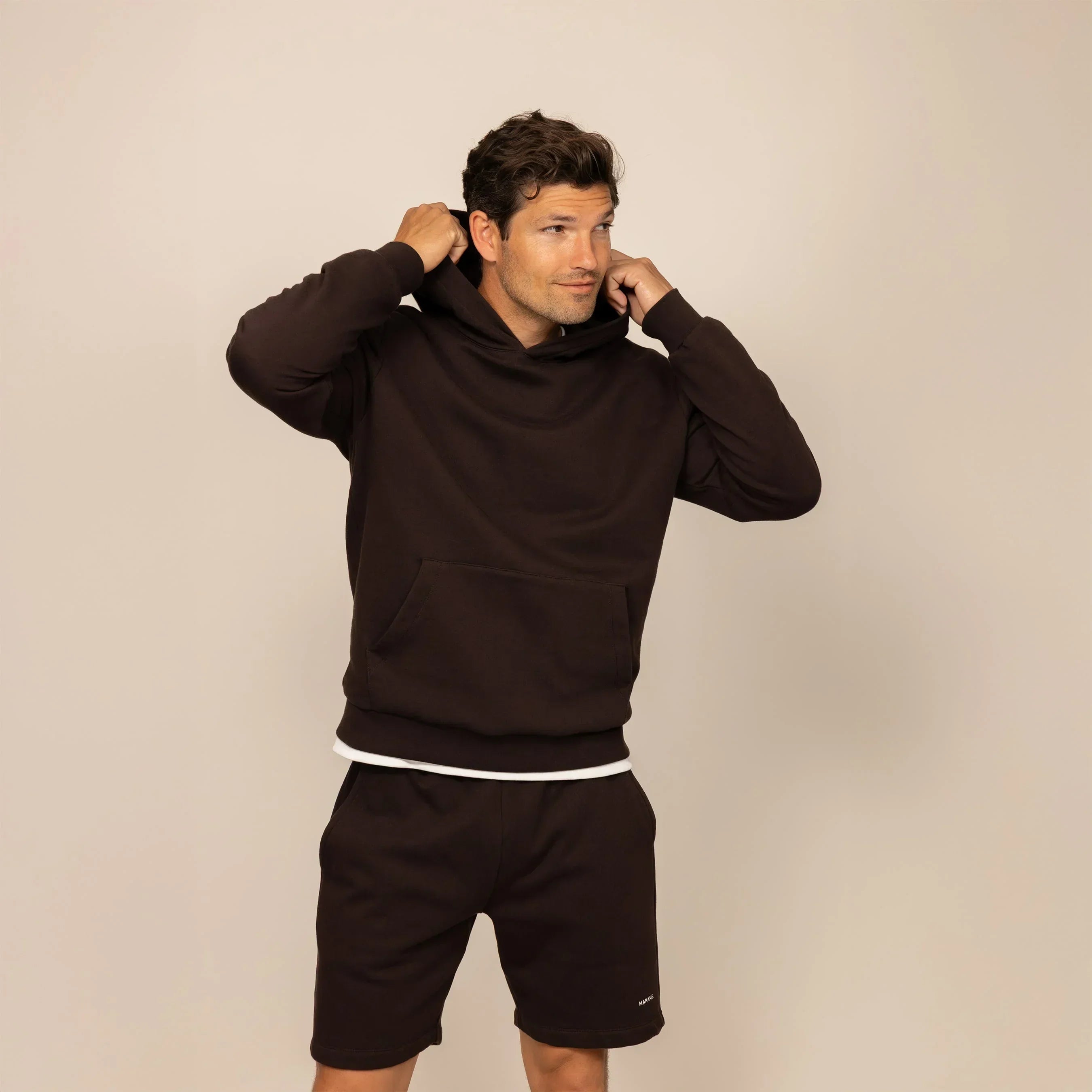 Man wearing a cotton fleece hoodie in Smoked Brown, front view.|smoked brown