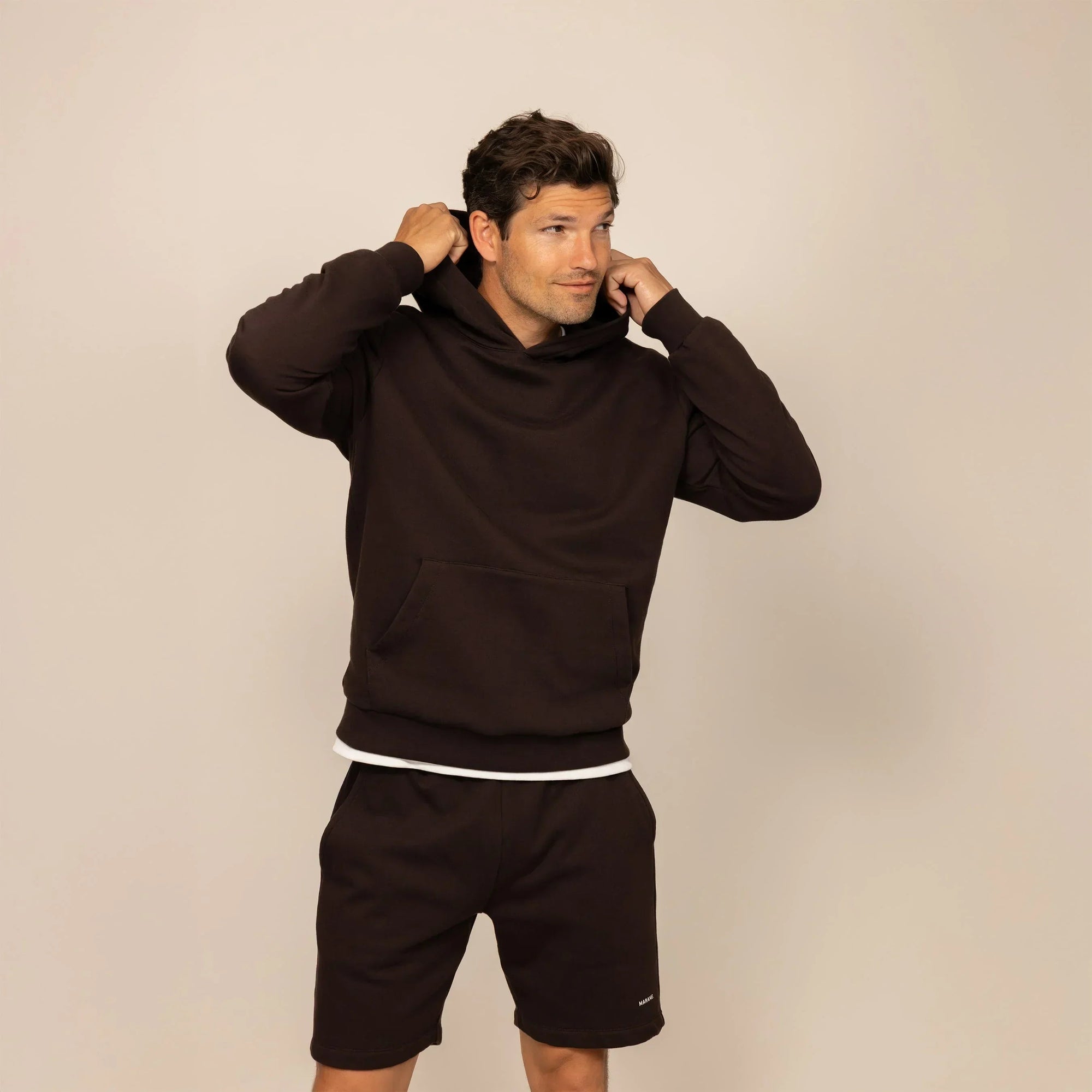 Man wearing a cotton fleece hoodie in Smoked Brown, front view.|smoked brown