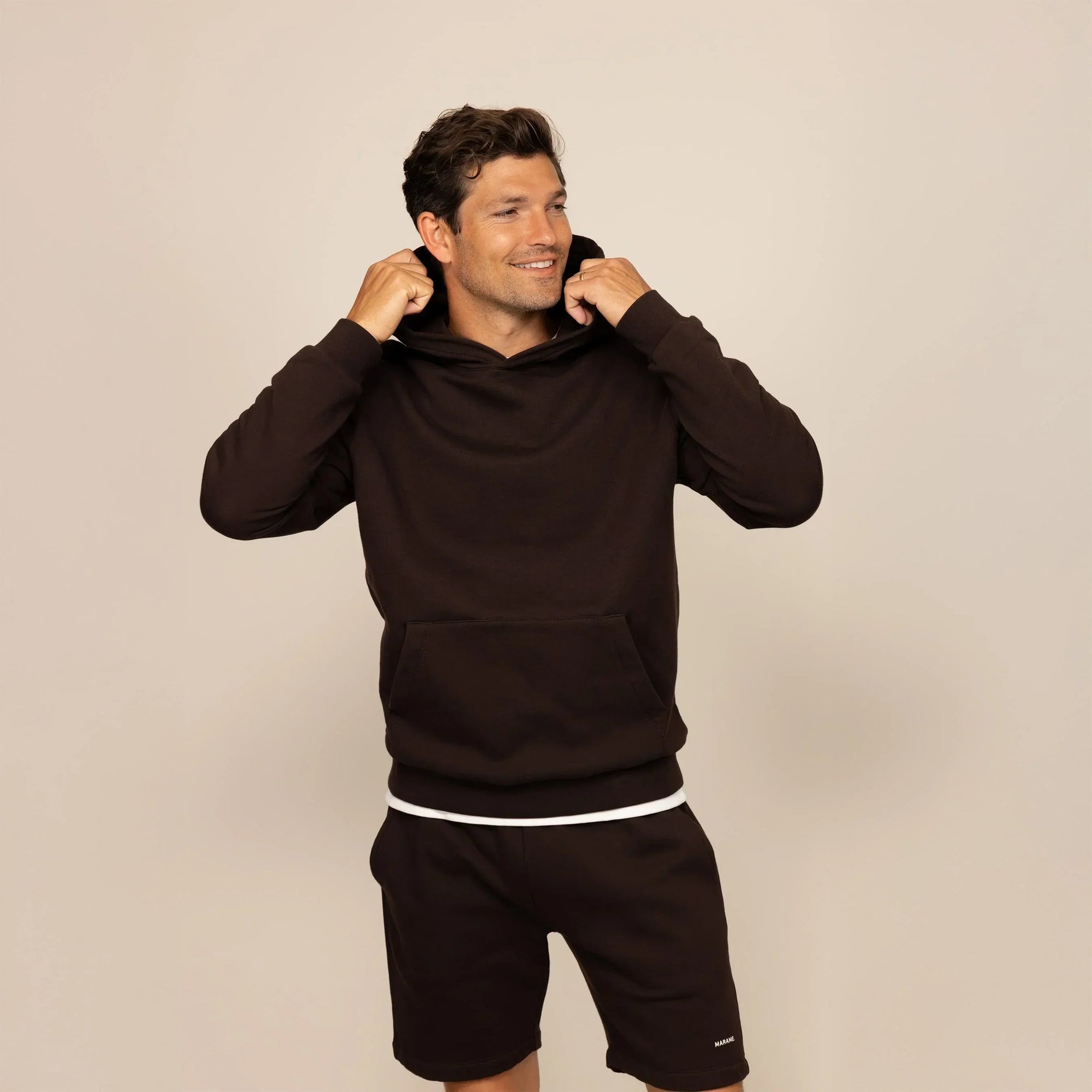 Man wearing a Marame cotton fleece hoodie in Smoked Brown, front view.|smoked brown