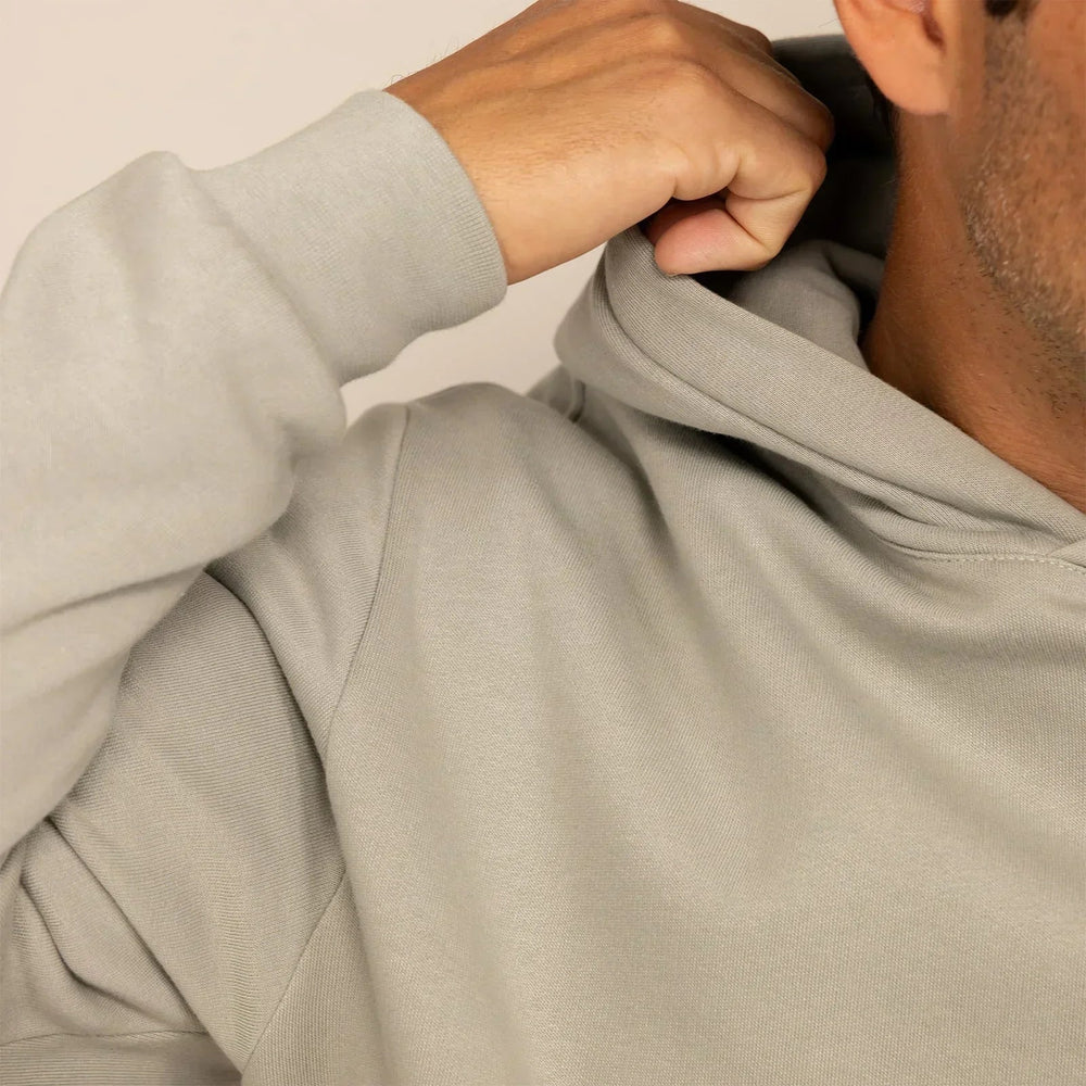 Man wearing a cotton fleece hoodie in Wolf Grey, closeup.|wolf green