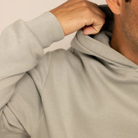 Man wearing a cotton fleece hoodie in Wolf Grey, closeup.|wolf green