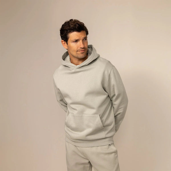 Man wearing a cotton fleece hoodie in Wolf Grey, front view.|wolf green