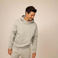 Man wearing a Marame cotton fleece hoodie in Wolf Grey, front view.