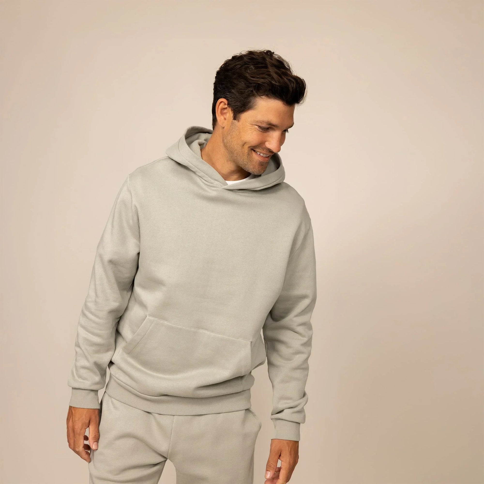 Man wearing a Marame cotton fleece hoodie in Wolf Grey, front view.|wolf green