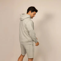 Man wearing a cotton fleece hoodie in Wolf Grey, rear view.