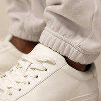 Man wearing Marame Cotton Fleece Joggers in Ash White, closeup.