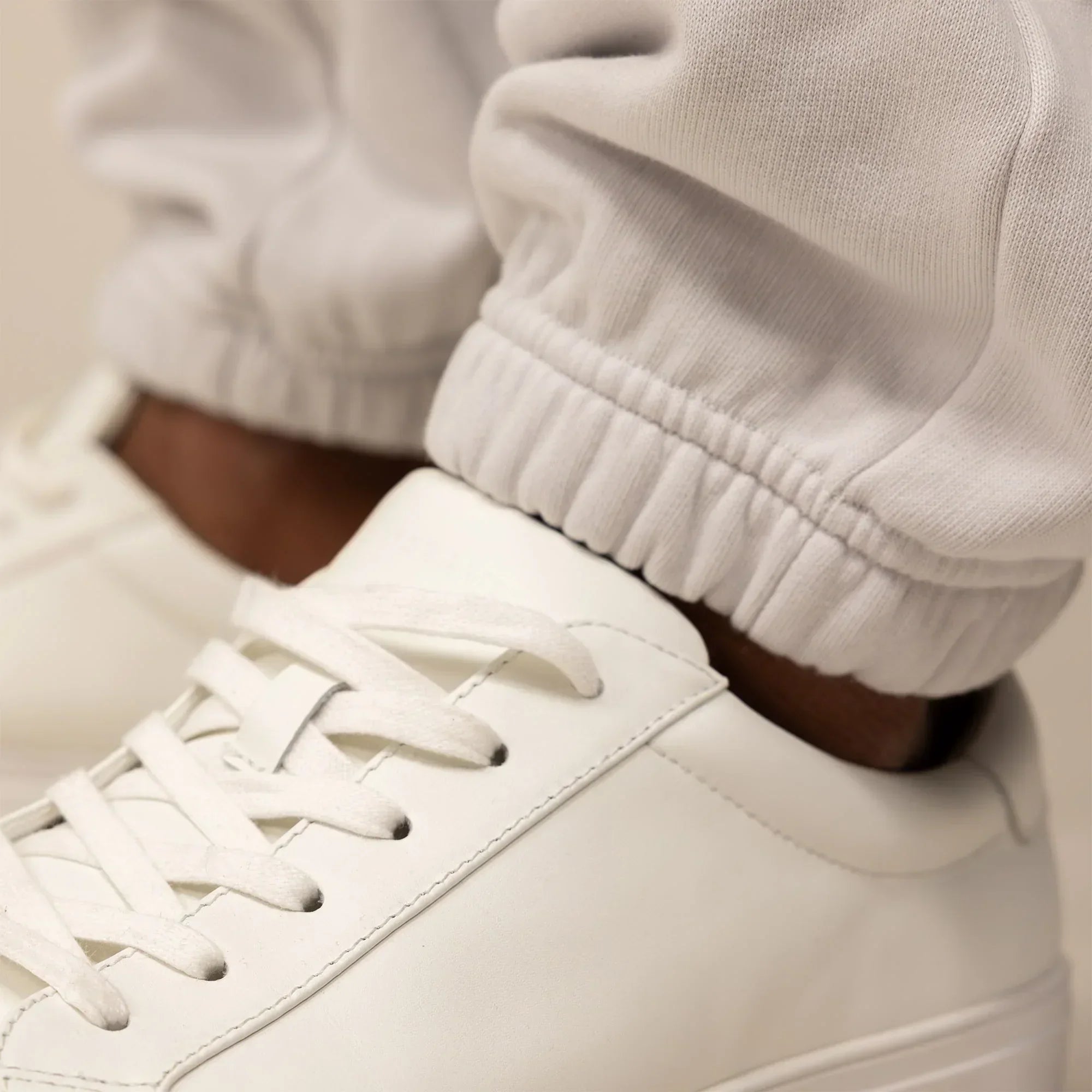 Man wearing Marame Cotton Fleece Joggers in Ash White, closeup.|ash white