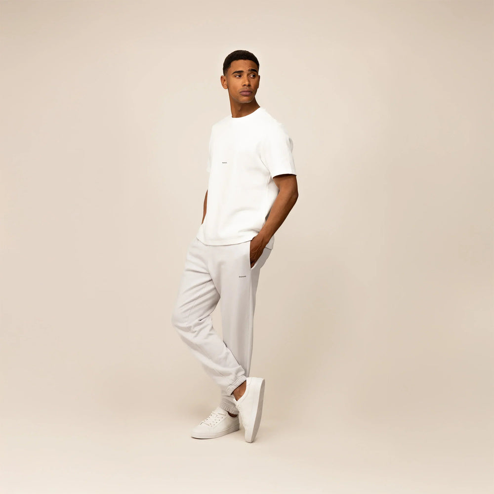 Man wearing Marame Cotton Fleece Joggers in Ash White, full view.|ash white