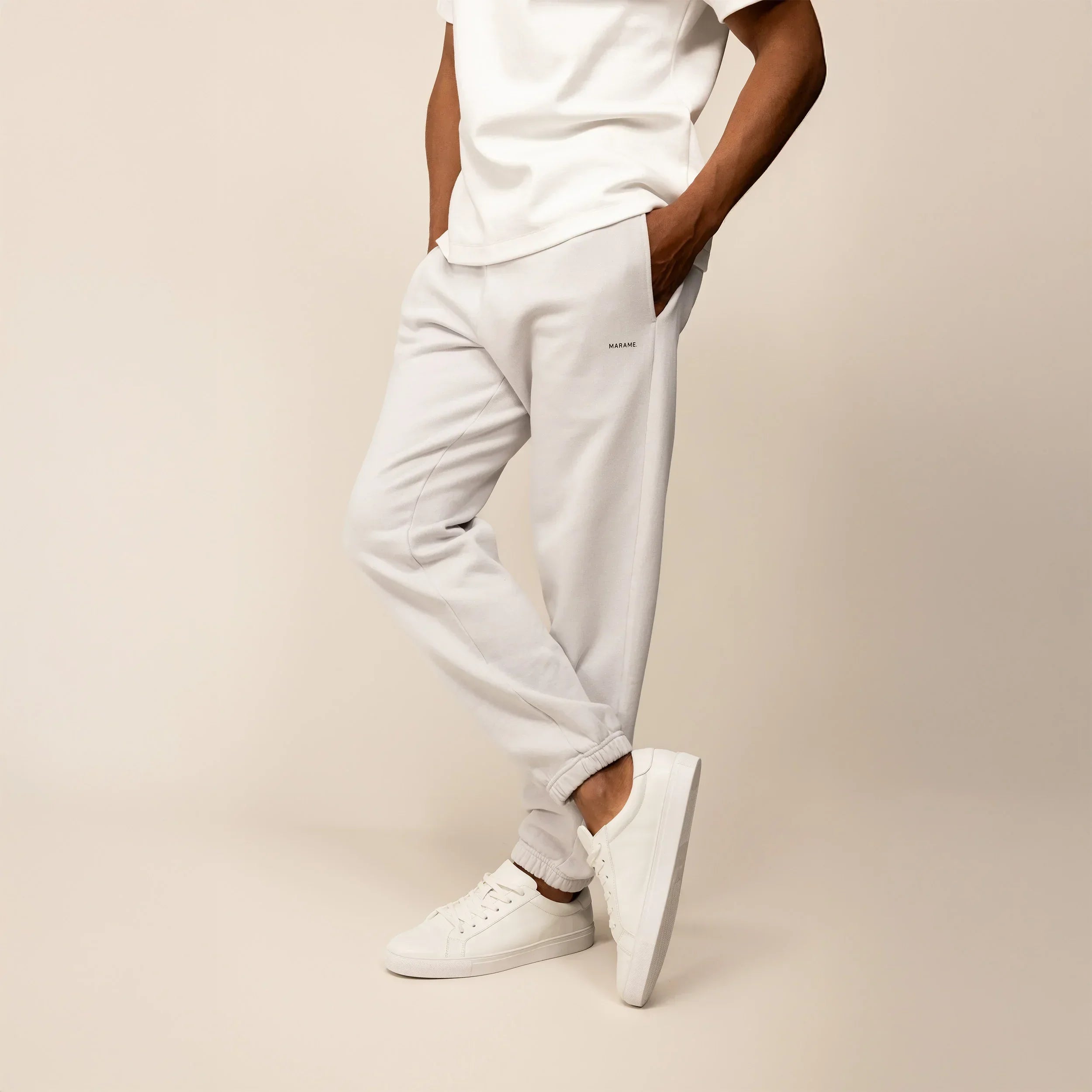 Man wearing Marame Cotton Fleece Joggers in Ash White, front view.|ash white