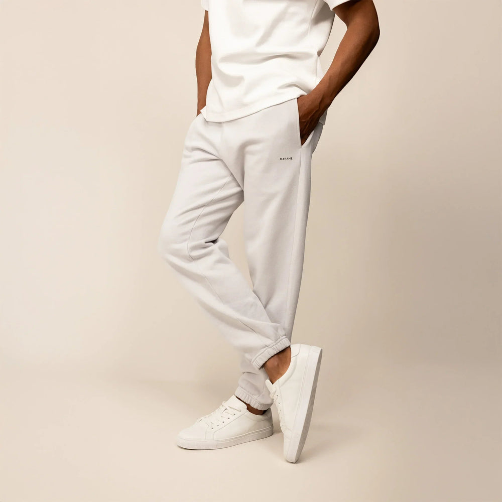 Man wearing Marame Cotton Fleece Joggers in Ash White, front view.|ash white