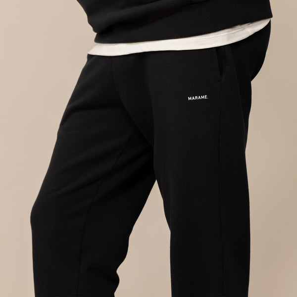 Man wearing Cotton Fleece Joggers in Black, front view.