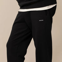 Man wearing Cotton Fleece Joggers in Black, front view.|black