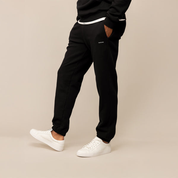 Man wearing Marame Cotton Fleece Joggers in Black, front view.