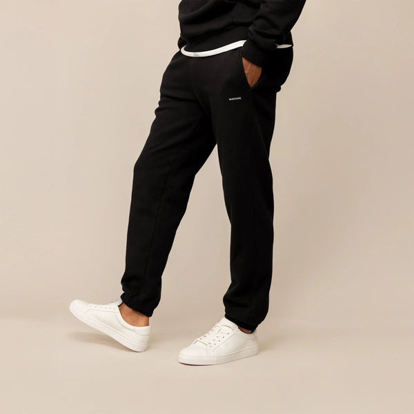 Man wearing Marame Cotton Fleece Joggers in Black, front view.|black