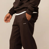 Man wearing Cotton Fleece Joggers in Smoked Brown, front view.|smoked brown