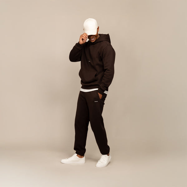 Man wearing Marame Cotton Fleece Joggers in Smoked Brown, full view.