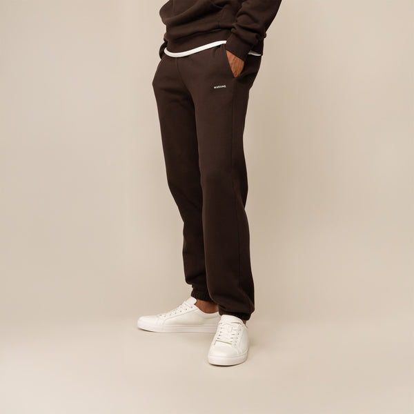 Man wearing Marame Cotton Fleece Joggers in Smoked Brown, front view.