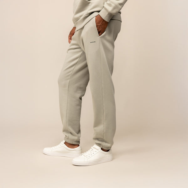 Man wearing Marame Cotton Fleece Joggers in Wolf Grey, front view.