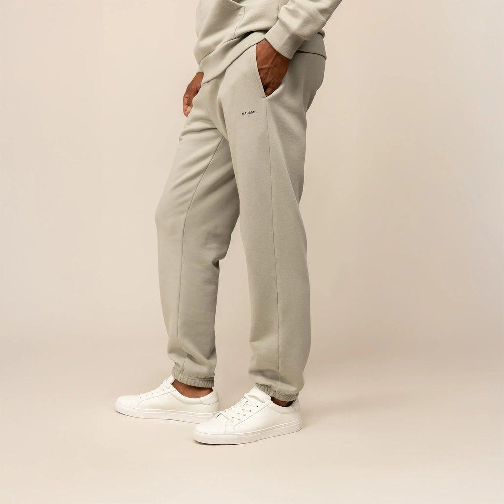 Man wearing Marame Cotton Fleece Joggers in Wolf Grey, front view.