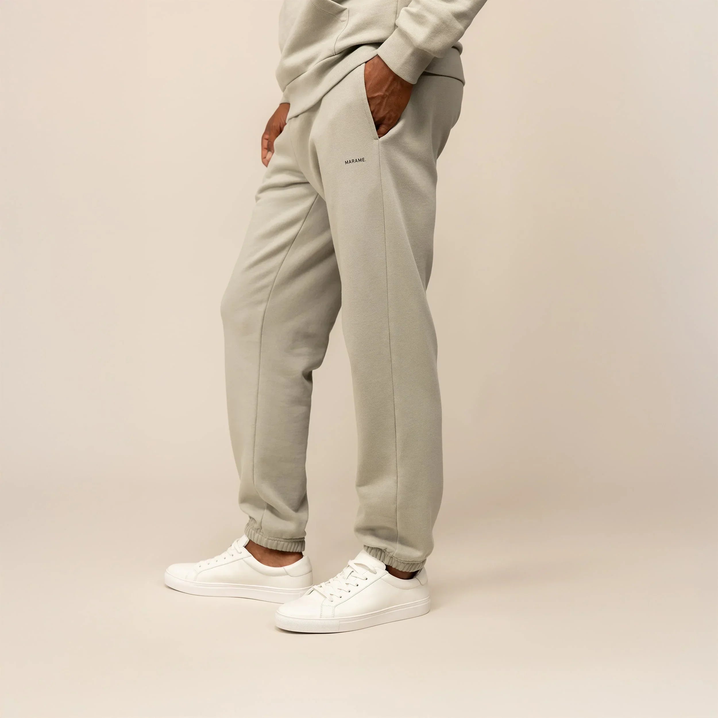 Man wearing Marame Cotton Fleece Joggers in Wolf Grey, front view.|wolf green