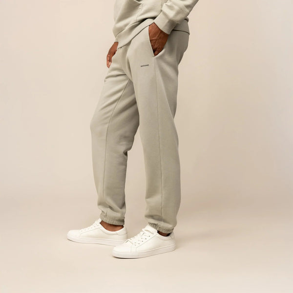 Man wearing Marame Cotton Fleece Joggers in Wolf Grey, front view.|wolf green
