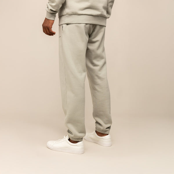 Man wearing Cotton Fleece Joggers in Wolf Grey, rear view.