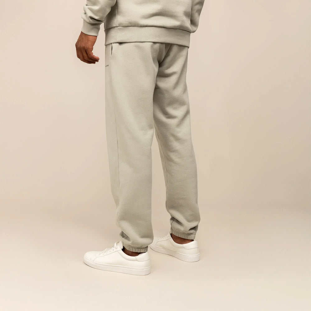 Man wearing Cotton Fleece Joggers in Wolf Grey, rear view.