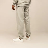 Man wearing Cotton Fleece Joggers in Wolf Grey, rear view.
