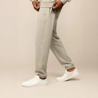 Man wearing Marame Cotton Fleece Joggers in Wolf Grey, side view.