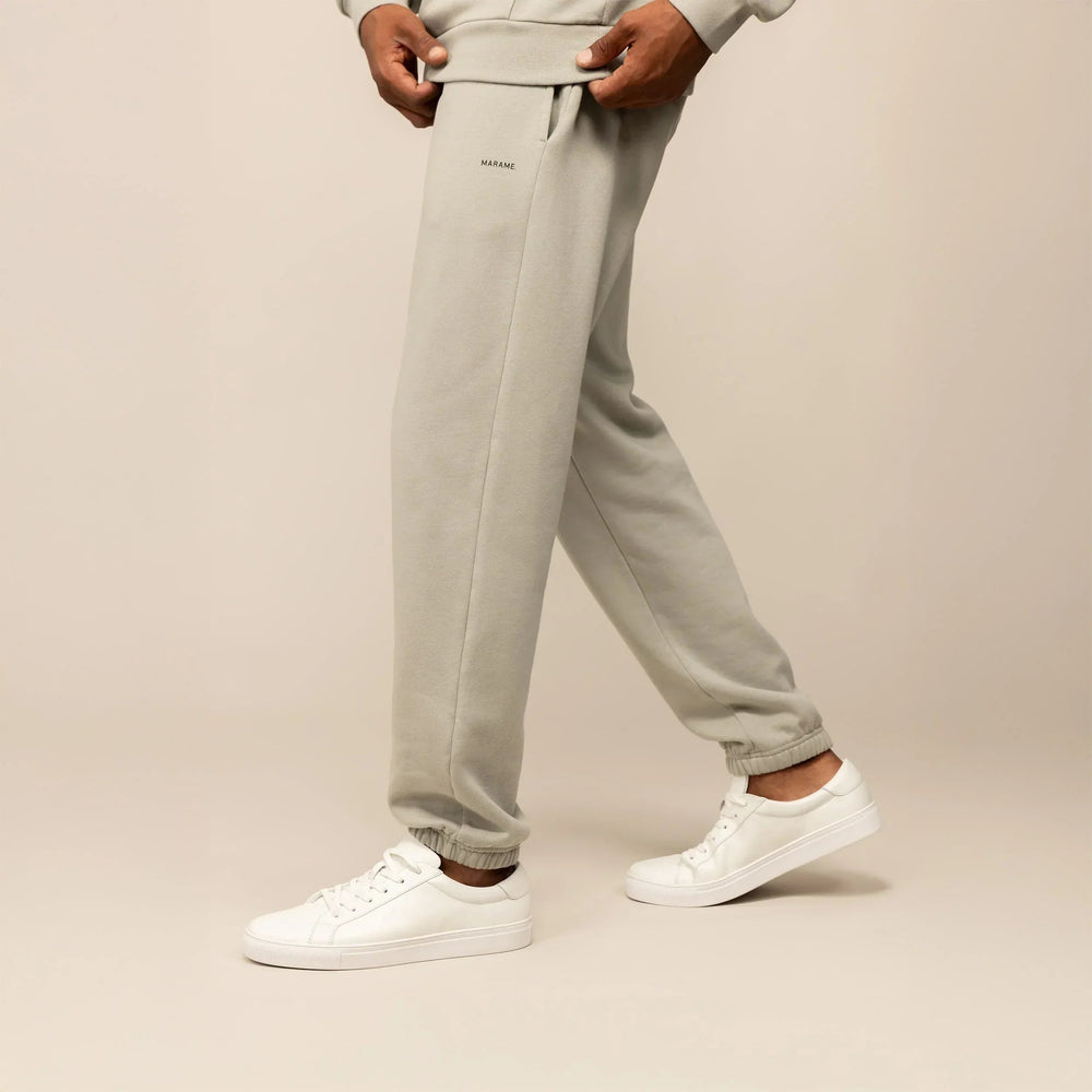 Man wearing Marame Cotton Fleece Joggers in Wolf Grey, side view.|wolf green