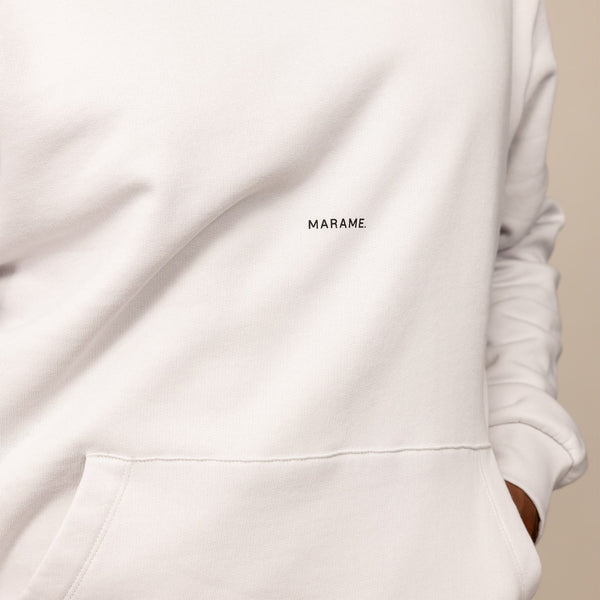Man wearing a cotton fleece Logo Hoodie in Ash White, closeup.