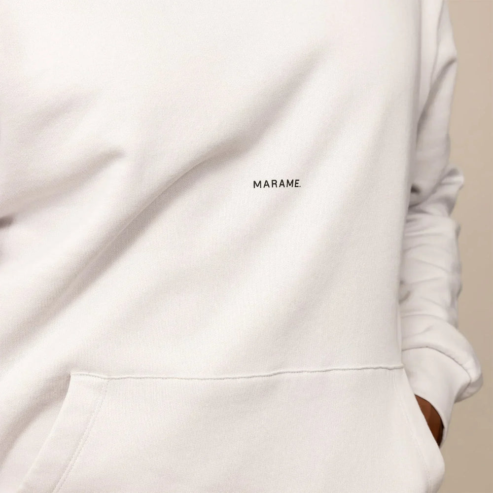 Man wearing a cotton fleece Logo Hoodie in Ash White, closeup.