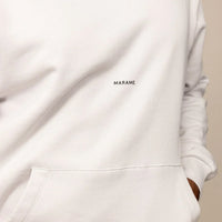 Man wearing a cotton fleece Logo Hoodie in Ash White, closeup.