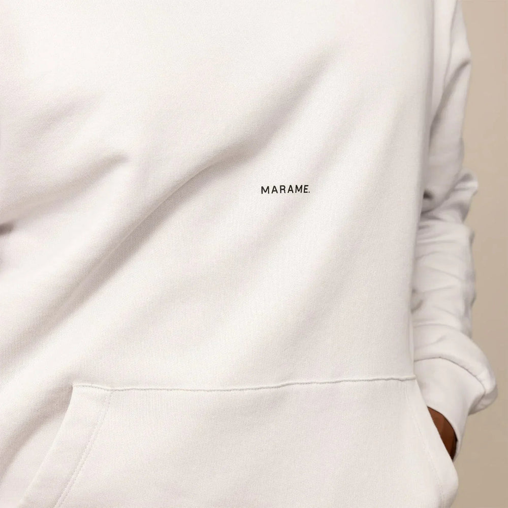 Man wearing a cotton fleece Logo Hoodie in Ash White, closeup.|ash white