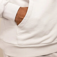 Man wearing a Marame cotton fleece Logo Hoodie in Ash White, closeup.